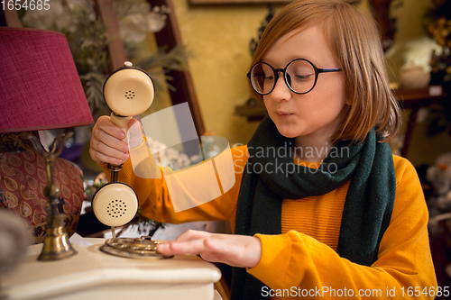 Image of Cheerful little boy looking for home decoration and holiday\'s gifts in household store