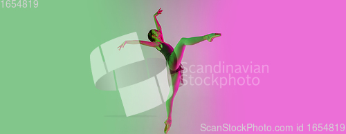 Image of Young and graceful ballet dancer isolated on gradient pink-green studio background in neon light. Art in motion