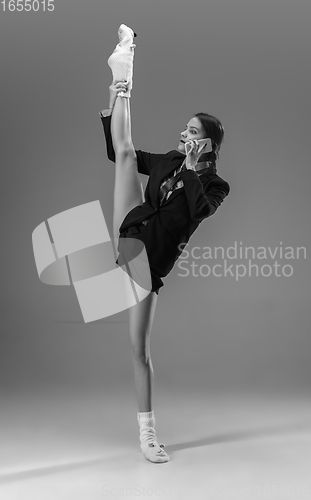 Image of Young fashionable, stylish woman wearing jacket and socks working from home. Fashion during insulation \'cause of coronavirus pandemic