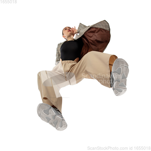 Image of Young stylish woman in modern street style outfit isolated on white background, shot from the bottom