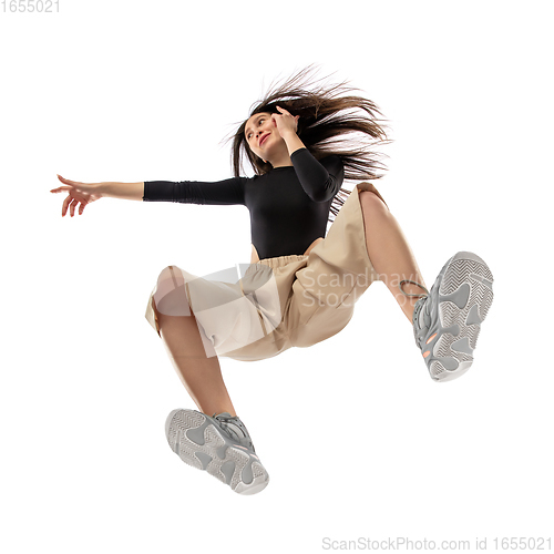 Image of Young stylish woman in modern street style outfit isolated on white background, shot from the bottom