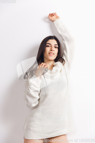 Image of Portrait of beautiful woman isolated on white studio background. Comfort, warm in winter concept