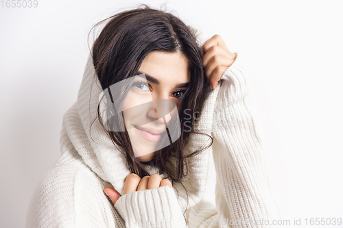 Image of Portrait of beautiful woman isolated on white studio background. Comfort, warm in winter concept