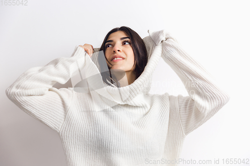 Image of Portrait of beautiful woman isolated on white studio background. Comfort, warm in winter concept