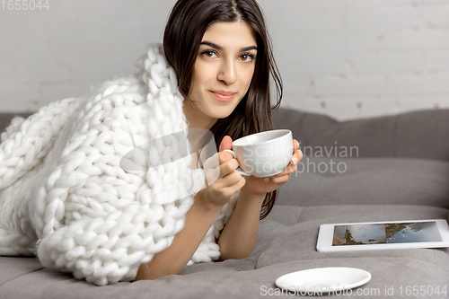 Image of Portrait of beautiful woman isolated on white studio background. Comfort, warm in winter concept