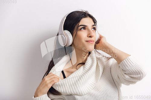 Image of Portrait of beautiful woman isolated on white studio background. Comfort, warm in winter concept