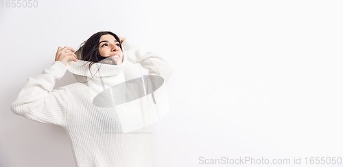 Image of Portrait of beautiful woman isolated on white studio background. Comfort, warm in winter concept