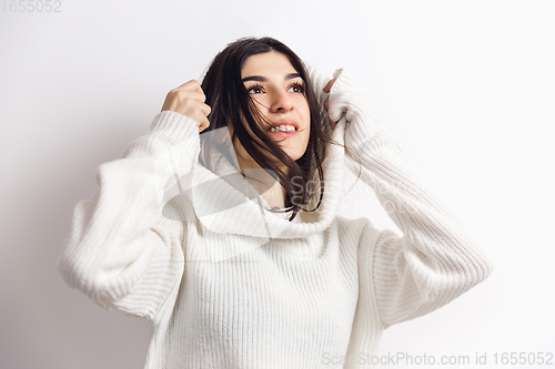 Image of Portrait of beautiful woman isolated on white studio background. Comfort, warm in winter concept