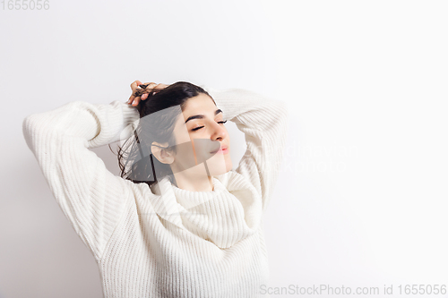 Image of Portrait of beautiful woman isolated on white studio background. Comfort, warm in winter concept