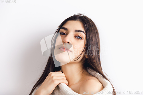 Image of Portrait of beautiful woman isolated on white studio background. Comfort, warm in winter concept