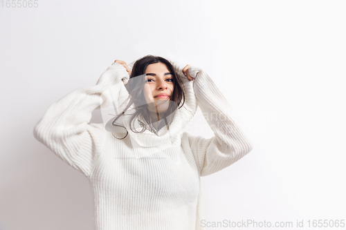 Image of Portrait of beautiful woman isolated on white studio background. Comfort, warm in winter concept