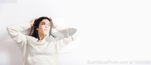 Image of Portrait of beautiful woman isolated on white studio background. Comfort, warm in winter concept