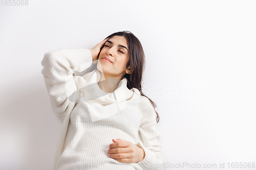 Image of Portrait of beautiful woman isolated on white studio background. Comfort, warm in winter concept