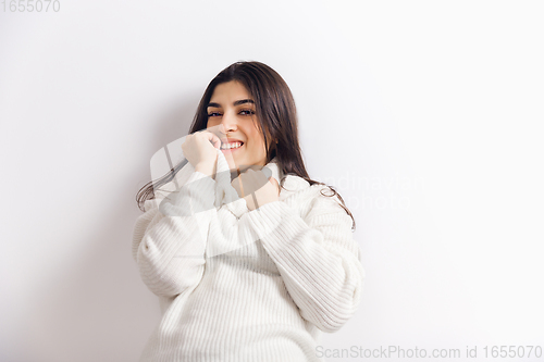 Image of Portrait of beautiful woman isolated on white studio background. Comfort, warm in winter concept