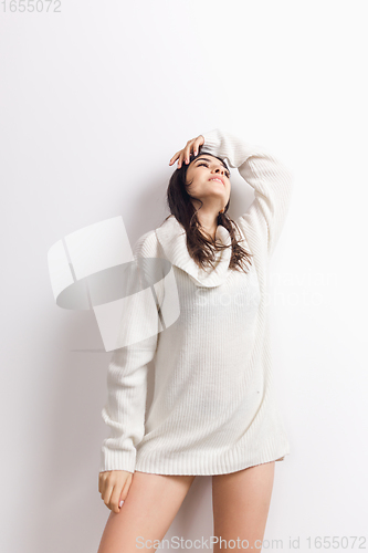 Image of Portrait of beautiful woman isolated on white studio background. Comfort, warm in winter concept