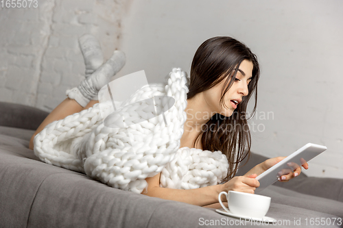 Image of Portrait of beautiful woman isolated on white studio background. Comfort, warm in winter concept