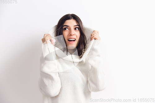 Image of Portrait of beautiful woman isolated on white studio background. Comfort, warm in winter concept