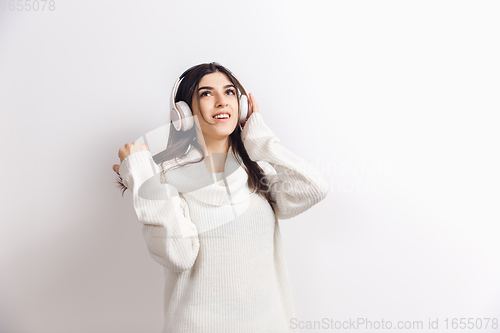 Image of Portrait of beautiful woman isolated on white studio background. Comfort, warm in winter concept