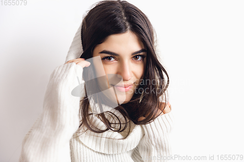 Image of Portrait of beautiful woman isolated on white studio background. Comfort, warm in winter concept