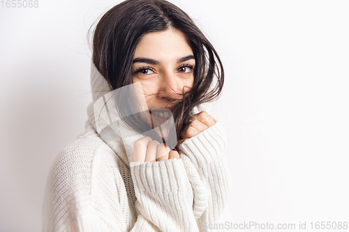 Image of Portrait of beautiful woman isolated on white studio background. Comfort, warm in winter concept