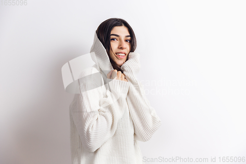 Image of Portrait of beautiful woman isolated on white studio background. Comfort, warm in winter concept