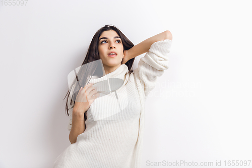 Image of Portrait of beautiful woman isolated on white studio background. Comfort, warm in winter concept