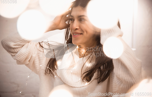 Image of Portrait of beautiful woman isolated on white studio background. Comfort, warm in winter concept