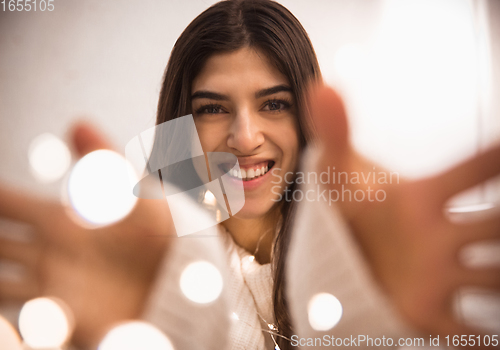 Image of Portrait of beautiful woman isolated on white studio background. Comfort, warm in winter concept