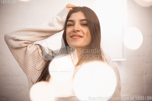 Image of Portrait of beautiful woman isolated on white studio background. Comfort, warm in winter concept