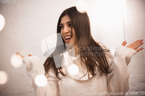 Image of Portrait of beautiful woman isolated on white studio background. Comfort, warm in winter concept