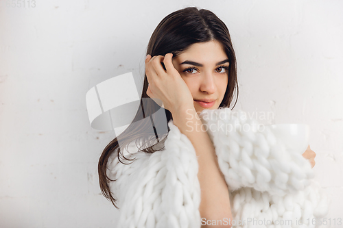 Image of Portrait of beautiful woman isolated on white studio background. Comfort, warm in winter concept