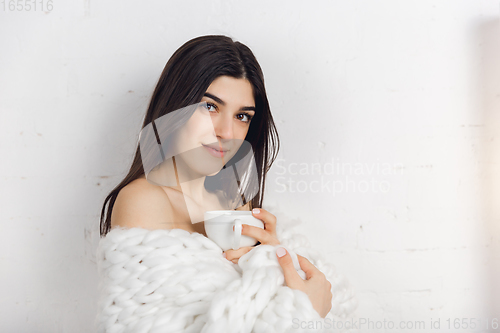Image of Portrait of beautiful woman isolated on white studio background. Comfort, warm in winter concept