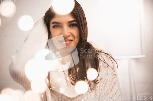Image of Portrait of beautiful woman isolated on white studio background. Comfort, warm in winter concept