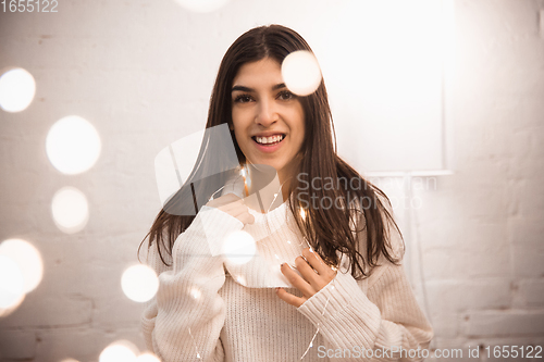 Image of Portrait of beautiful woman isolated on white studio background. Comfort, warm in winter concept