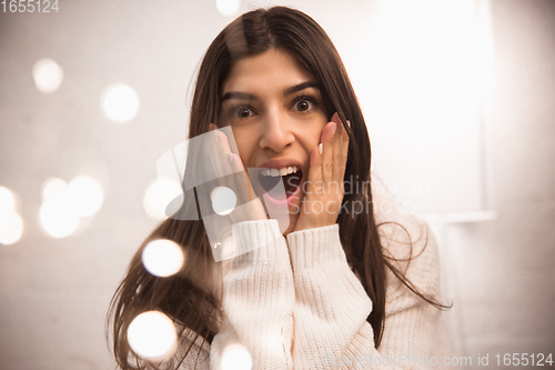 Image of Portrait of beautiful woman isolated on white studio background. Comfort, warm in winter concept