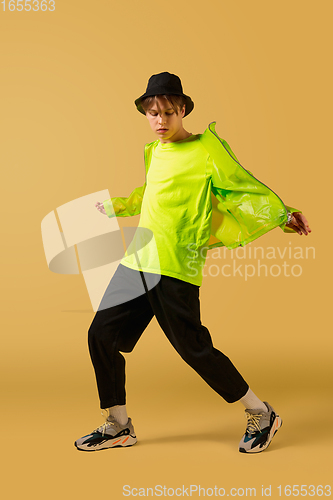 Image of Old-school fashioned young man dancing isolated on yellow background