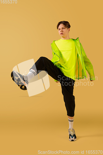 Image of Old-school fashioned young man dancing isolated on yellow background