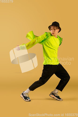 Image of Old-school fashioned young man dancing isolated on yellow background