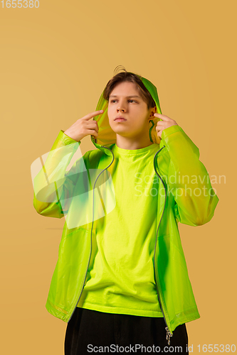 Image of Old-school fashioned young man dancing isolated on yellow background