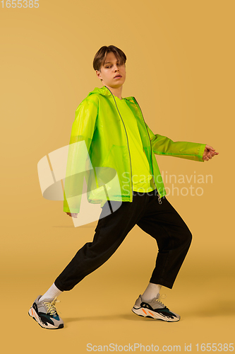 Image of Old-school fashioned young man dancing isolated on yellow background