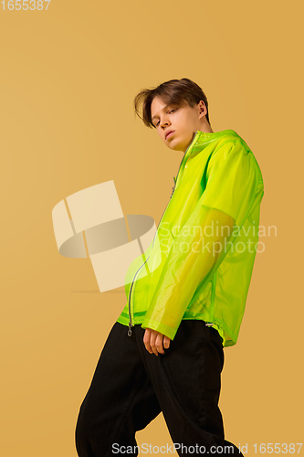 Image of Old-school fashioned young man dancing isolated on yellow background