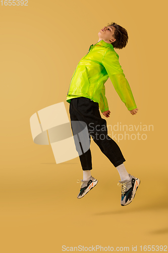 Image of Old-school fashioned young man dancing isolated on yellow background