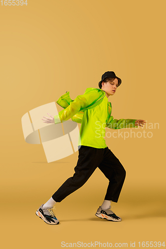 Image of Old-school fashioned young man dancing isolated on yellow background