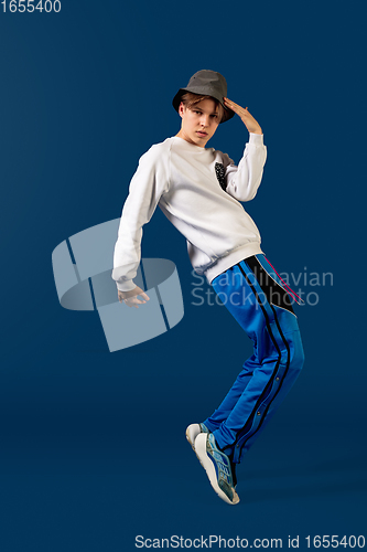 Image of Old-school fashioned young man dancing isolated on blue background