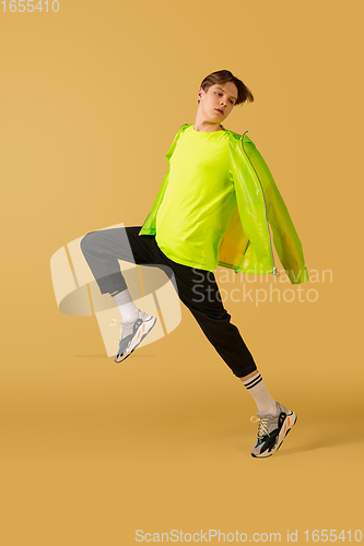 Image of Old-school fashioned young man dancing isolated on yellow background