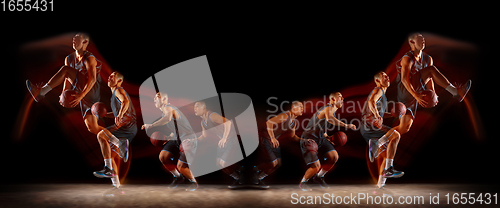 Image of Young purposeful basketball player training in action isolated on black background with fire flames. Mirror, strobe light effect, reflection