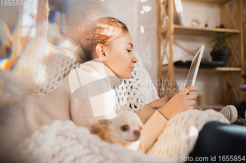 Image of Young woman enjoying her domestic life. Home comfort, winter and holidays time