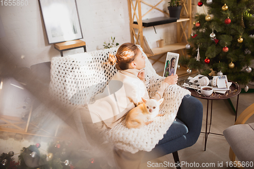 Image of Young woman enjoying her domestic life. Home comfort, winter and holidays time