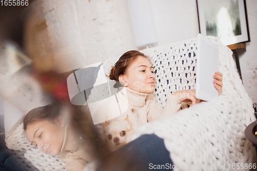 Image of Young woman enjoying her domestic life. Home comfort, winter and holidays time