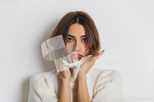 Image of Portrait of beautiful woman isolated on white studio background. Comfort, warm in winter concept